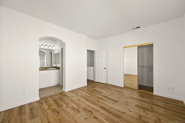a view of a room with wooden floor and closet