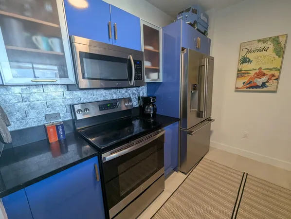 a kitchen with stainless steel appliances a stove a microwave and a refrigerator