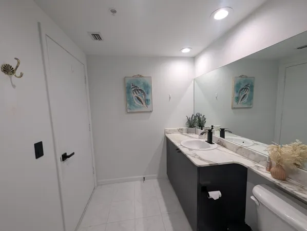 a bathroom with a sink vanity and mirror