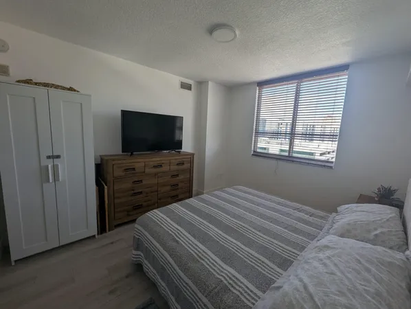 a bedroom with a bed and a television in it