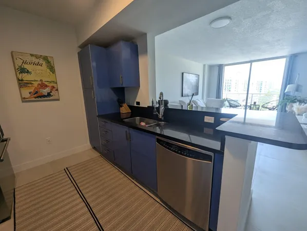 a kitchen with granite countertop a sink and a wooden cabinets