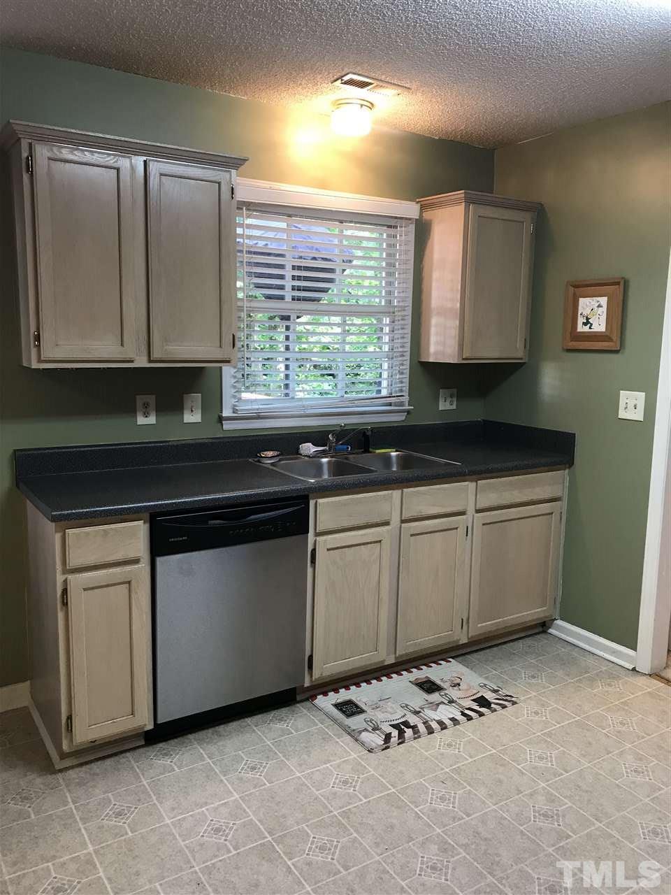 3609 Rubra Circle Raleigh, NC 27616 - Photo 4 of 15 Kitchen window overlooks large deck shaded by hardwood trees