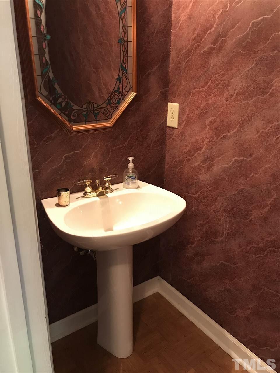 3609 Rubra Circle Raleigh, NC 27616 - Photo 7 of 15 First Floor half bath with pedestal sink and designer mirror.