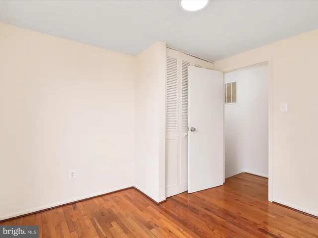 a view of hallway with wooden floor