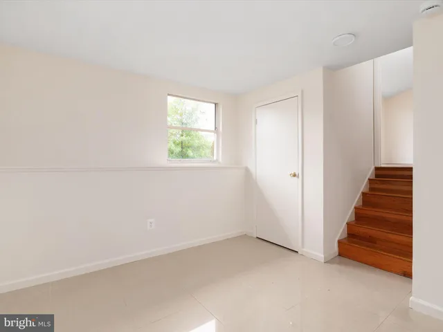 a view of an empty room with stairs