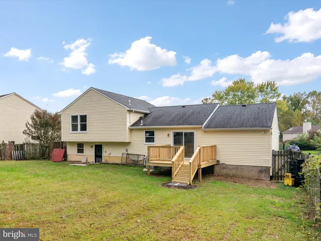 a view of a house with a yard and sitting area