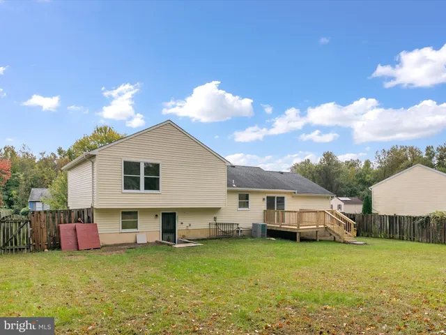 a view of a house with a yard and a patio
