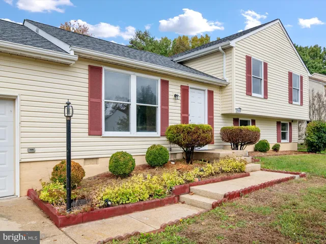a front view of a house with garden and patio