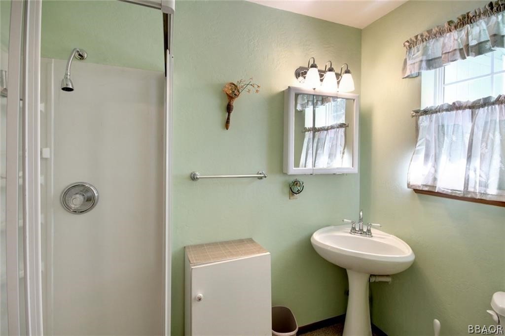 650 Riverside Avenue Sugarloaf, CA 92386 - Photo 11 of 15 a bathroom with a sink a mirror and a window