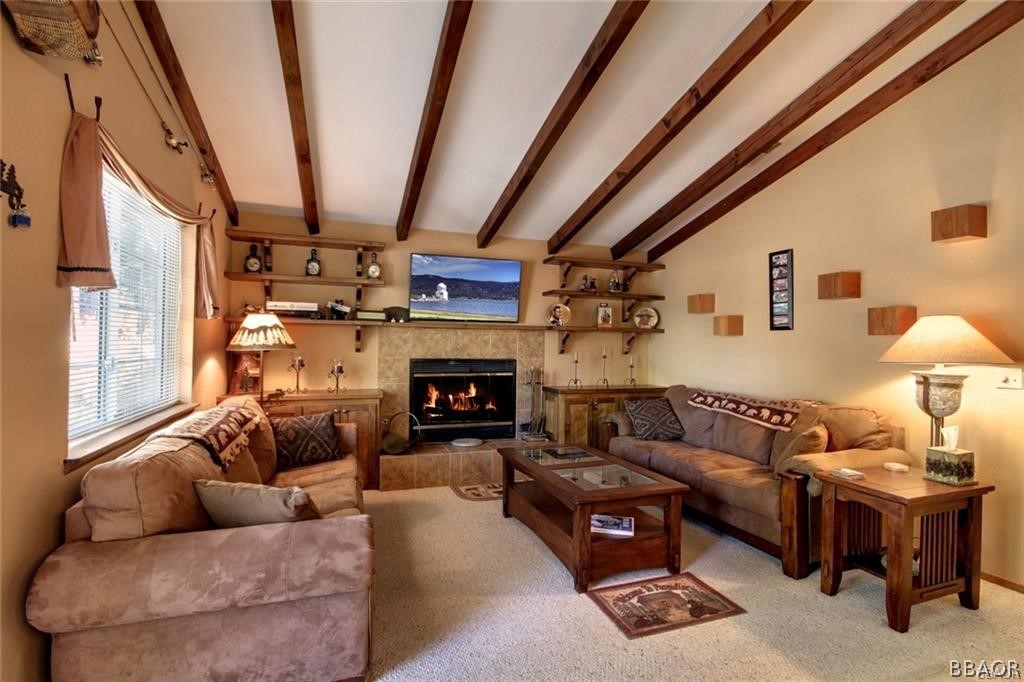 650 Riverside Avenue Sugarloaf, CA 92386 - Photo 2 of 15 a living room with furniture a fireplace and a large window