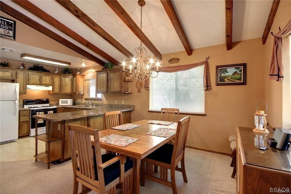 650 Riverside Avenue Sugarloaf, CA 92386 - Photo 4 of 15 a view of a dining room with furniture and a chandelier