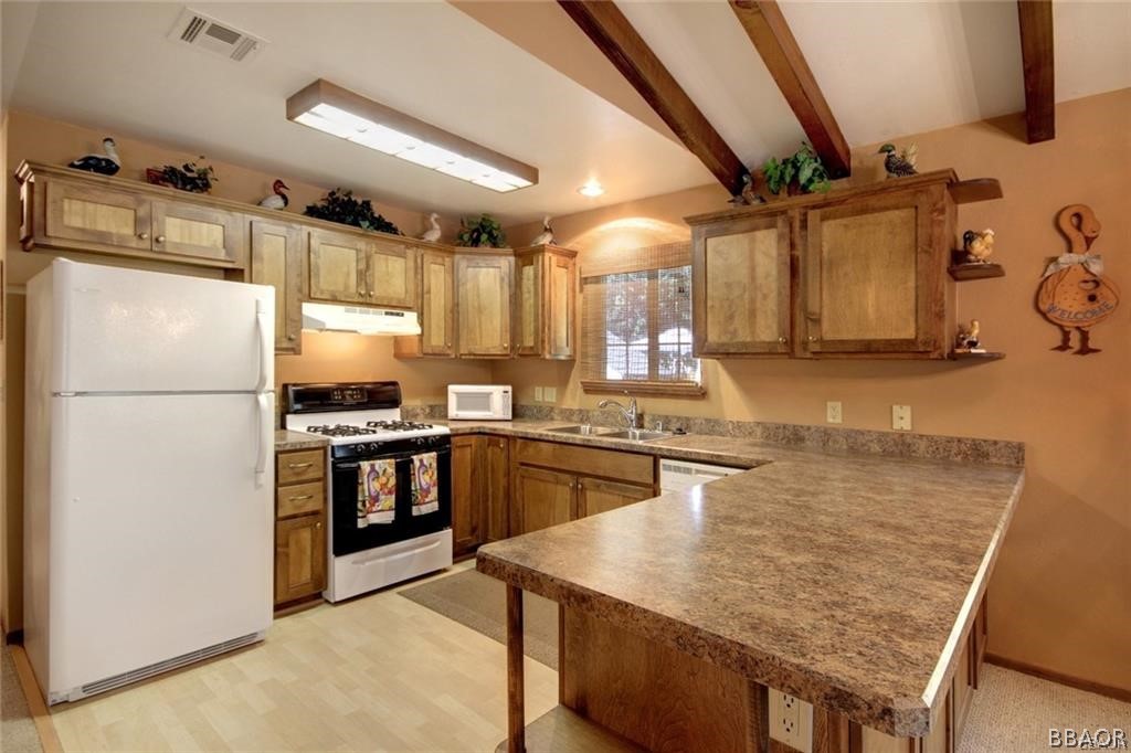 650 Riverside Avenue Sugarloaf, CA 92386 - Photo 5 of 15 a kitchen with granite countertop a refrigerator stove top oven and sink