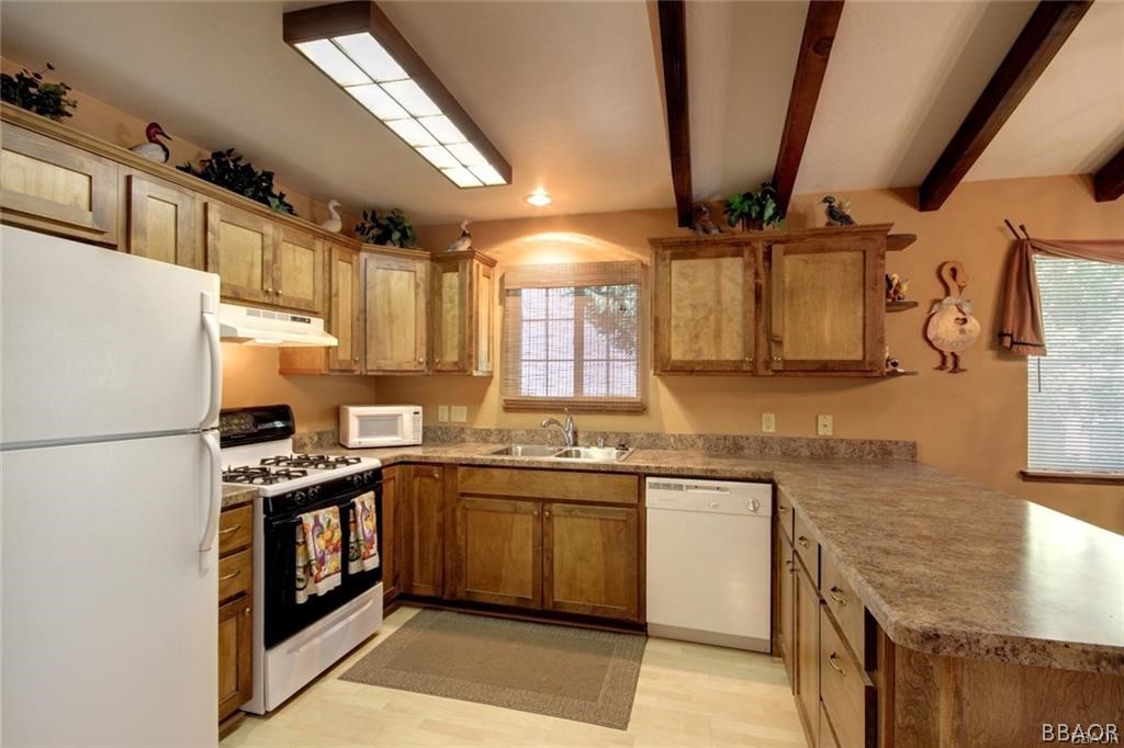 650 Riverside Avenue Sugarloaf, CA 92386 - Photo 6 of 15 a kitchen with stainless steel appliances granite countertop a sink a stove and a refrigerator