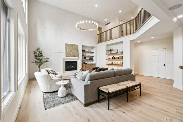 a living room with fireplace furniture and a large window