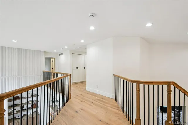 a view of a hallway with wooden floor