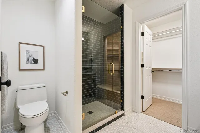 a bathroom with a glass shower door