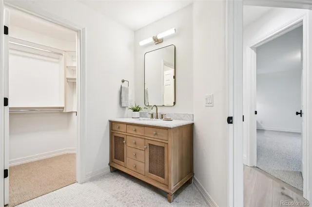 a bathroom with a granite countertop sink and a mirror