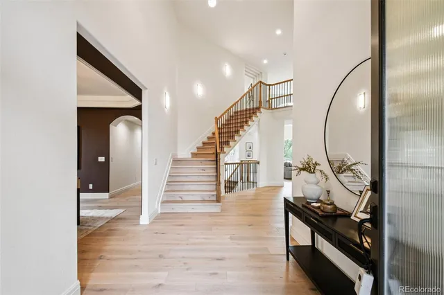 a view of a hallway with wooden floor and entryway