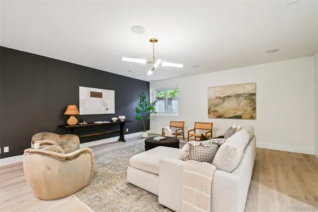 a living room with furniture a chandelier and a window