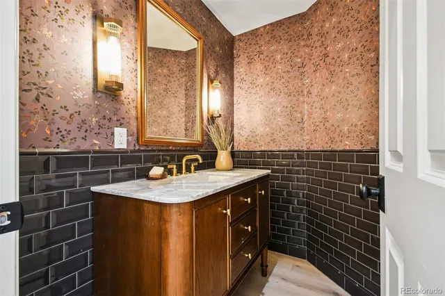 a bathroom with a granite countertop sink a toilet and a mirror