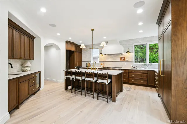 a kitchen with a table chairs sink and cabinets
