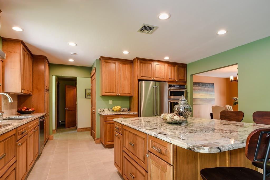 10 Lantern Road Framingham, MA 01702 - Photo 16 of 32 a kitchen with kitchen island granite countertop a sink and refrigerator