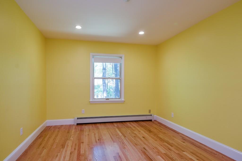 10 Lantern Road Framingham, MA 01702 - Photo 25 of 32 a view of empty room with wooden floor and fan