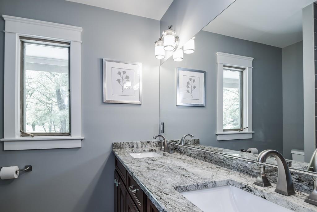10 Lantern Road Framingham, MA 01702 - Photo 27 of 32 a bathroom with a granite countertop sink a large mirror and a window