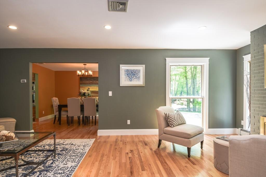 10 Lantern Road Framingham, MA 01702 - Photo 4 of 32 a living room with furniture a dining table and a floor to ceiling window