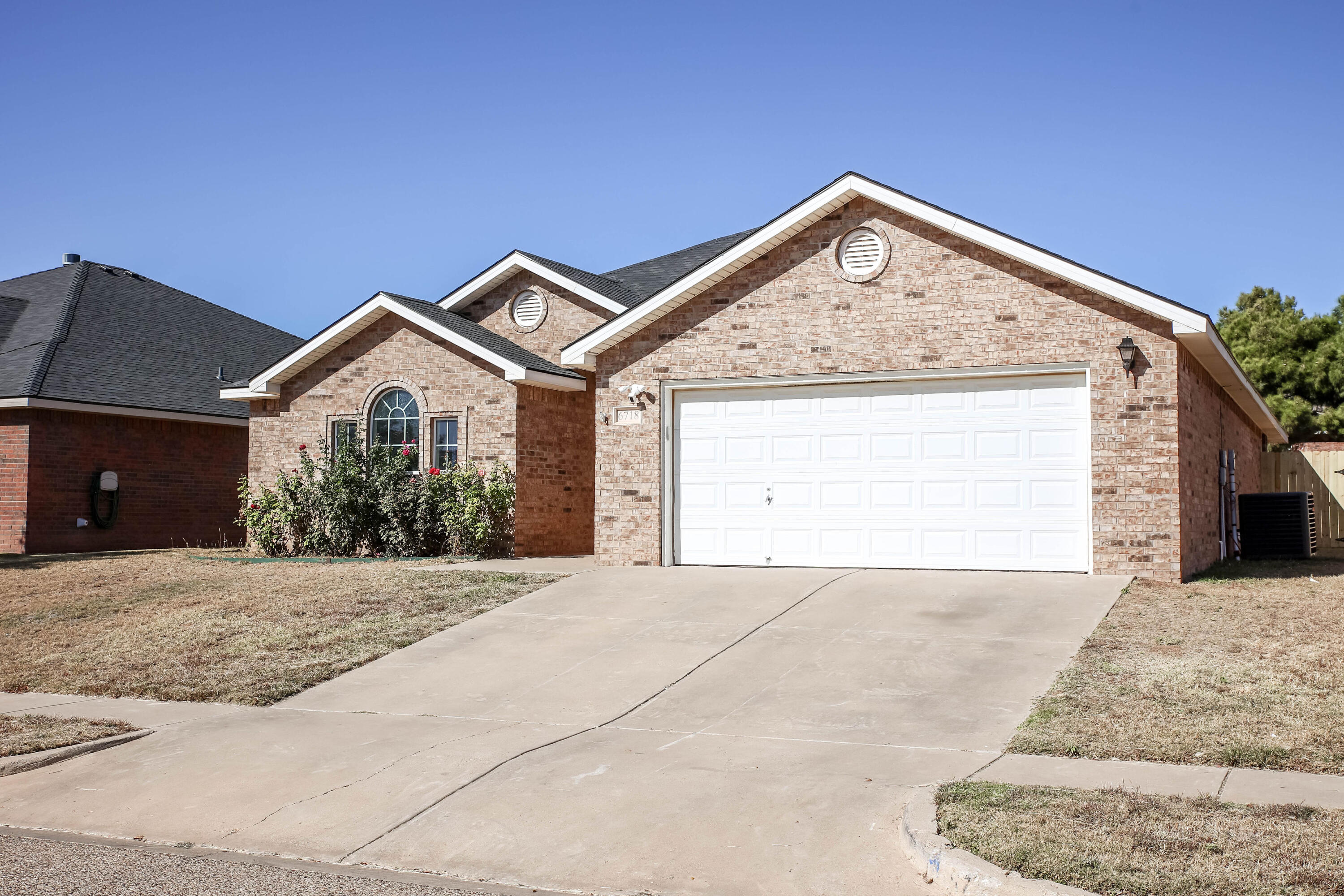 6718 92nd Street Lubbock, TX 79424 - Photo 1 of 31 a view of a house with a yard and garage
