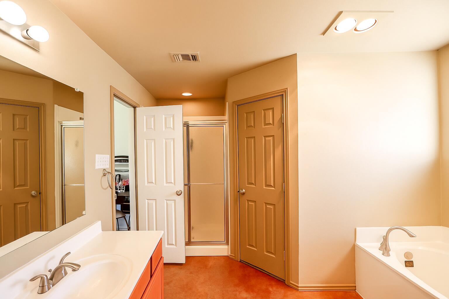 6718 92nd Street Lubbock, TX 79424 - Photo 13 of 31 a bathroom with a tub shower and a sink