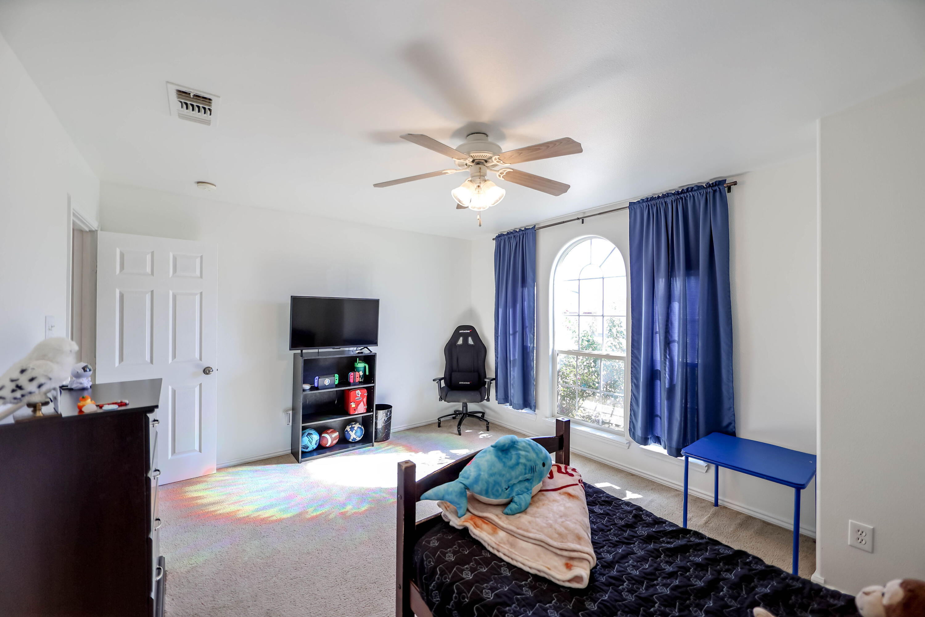 6718 92nd Street Lubbock, TX 79424 - Photo 15 of 31 a living room with furniture and a flat screen tv