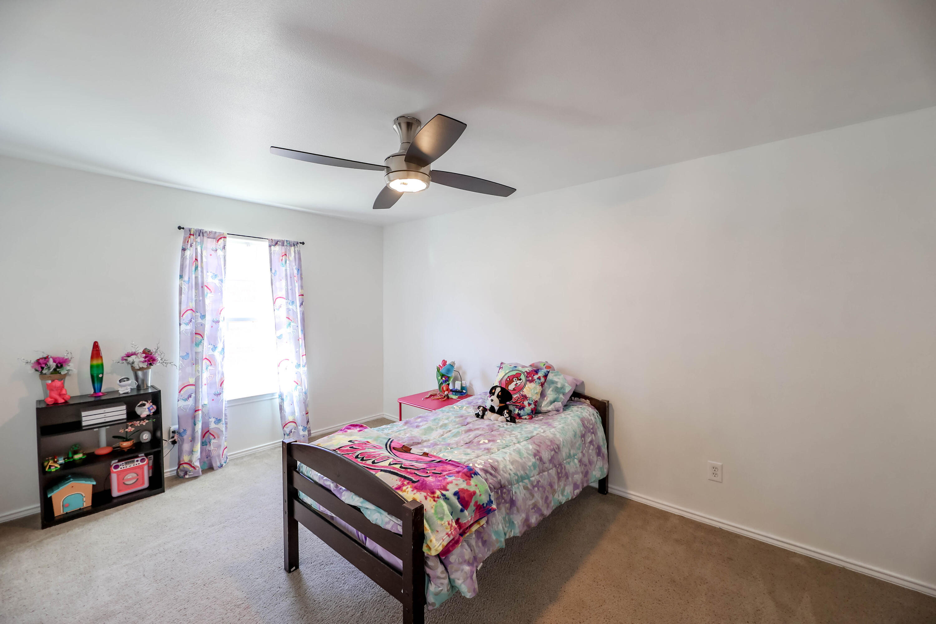 6718 92nd Street Lubbock, TX 79424 - Photo 19 of 31 a bedroom with a bed and a tv in it
