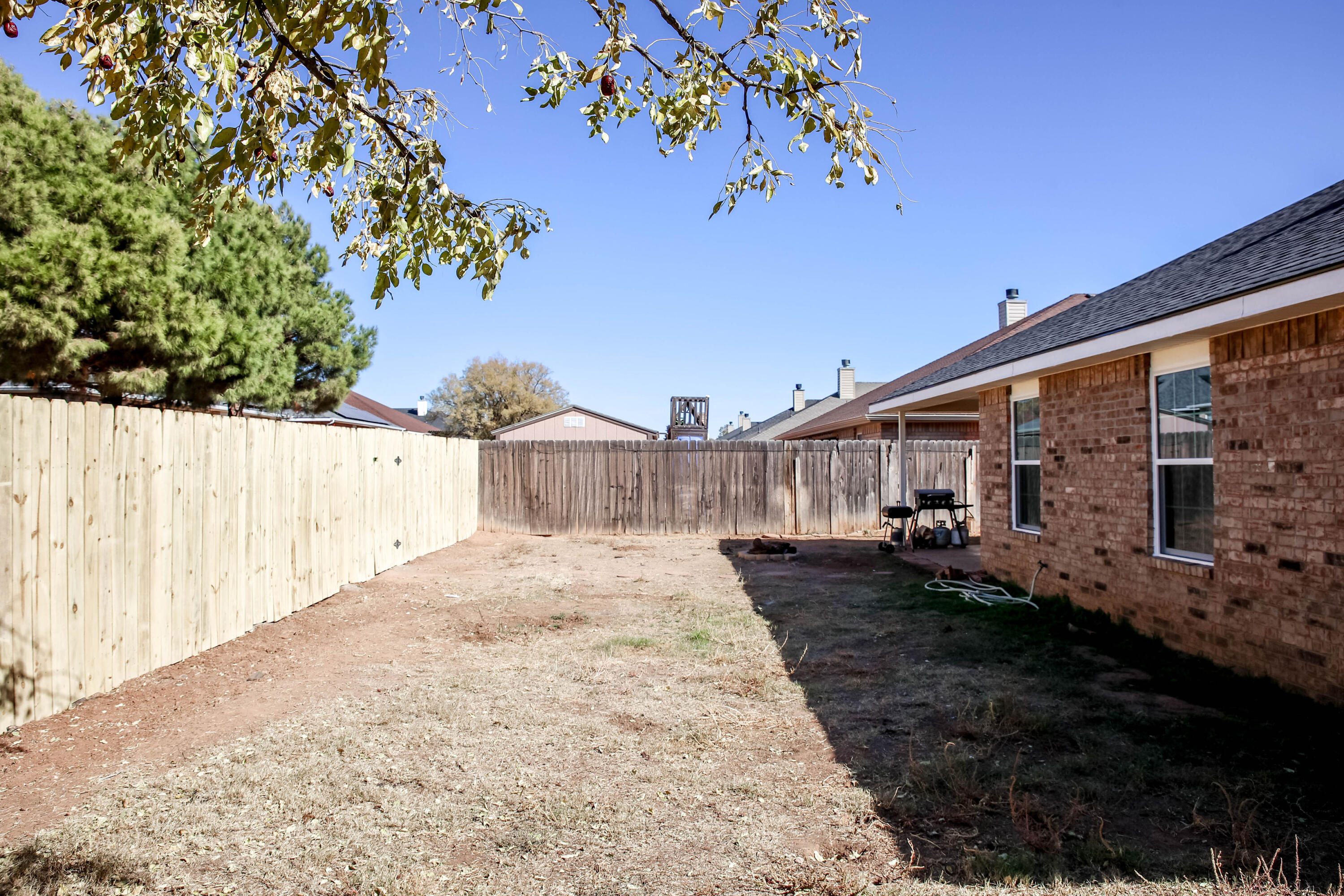 6718 92nd Street Lubbock, TX 79424 - Photo 29 of 31 a view of a house with a yard and potted plants