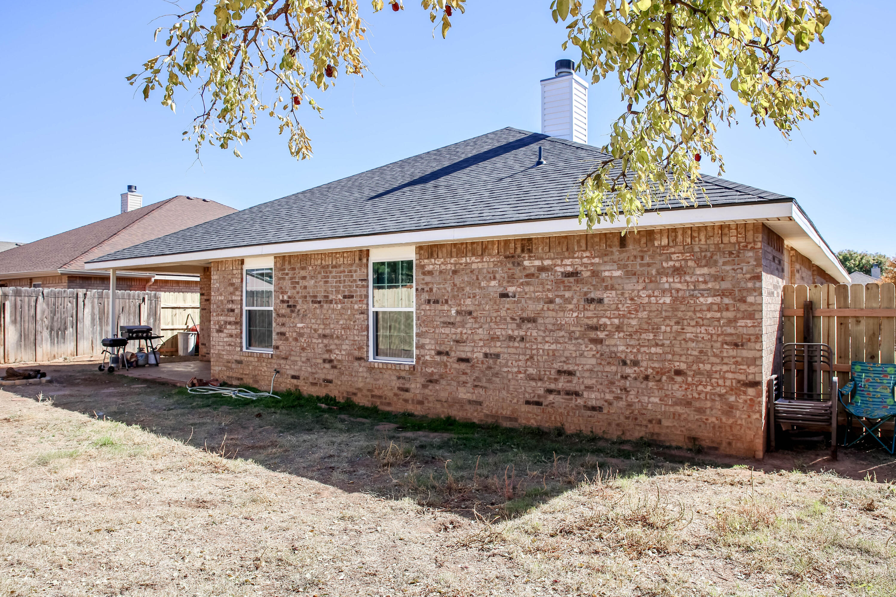 6718 92nd Street Lubbock, TX 79424 - Photo 30 of 31 a view of a backyard with a tree