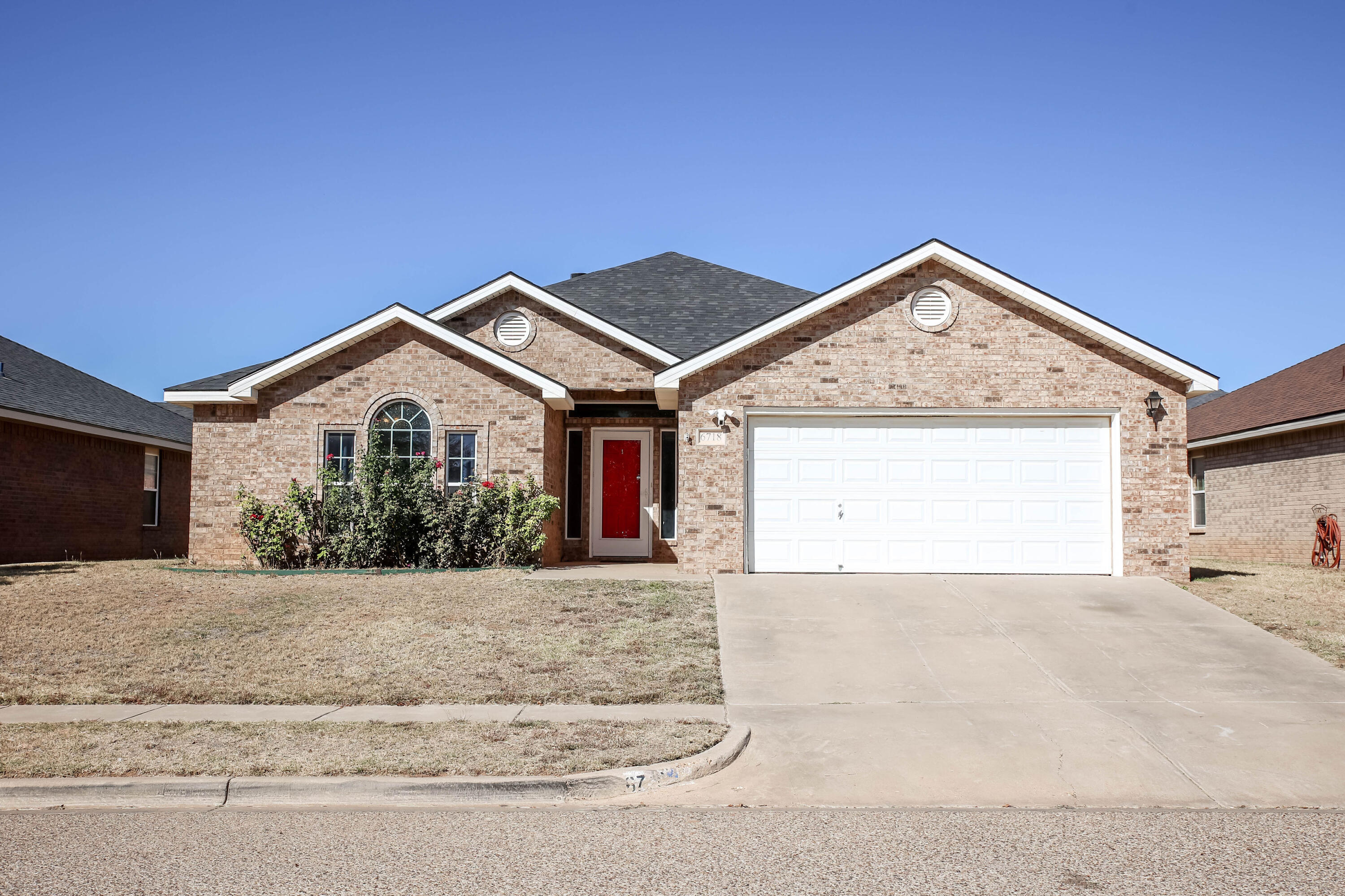 6718 92nd Street Lubbock, TX 79424 - Photo 31 of 31 a front view of a house with a yard and garage