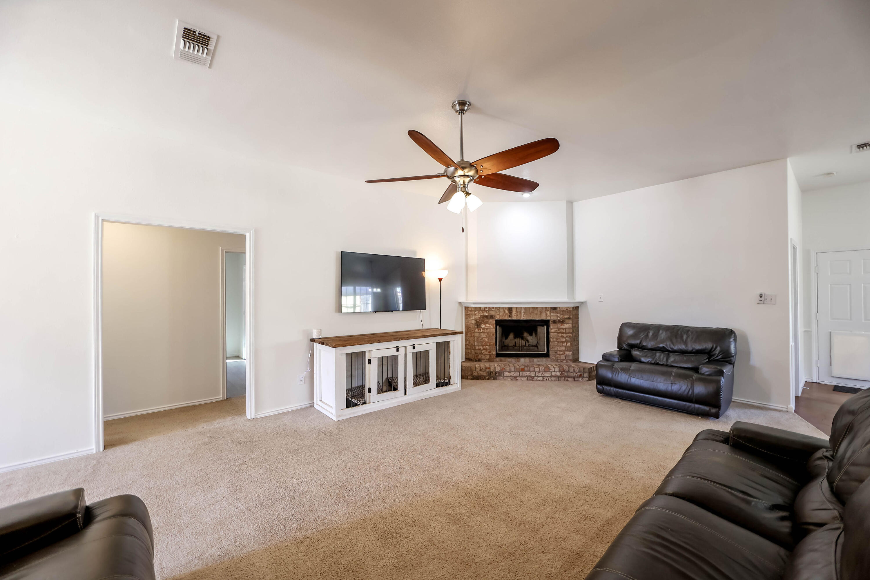 6718 92nd Street Lubbock, TX 79424 - Photo 4 of 31 a living room with furniture and a flat screen tv