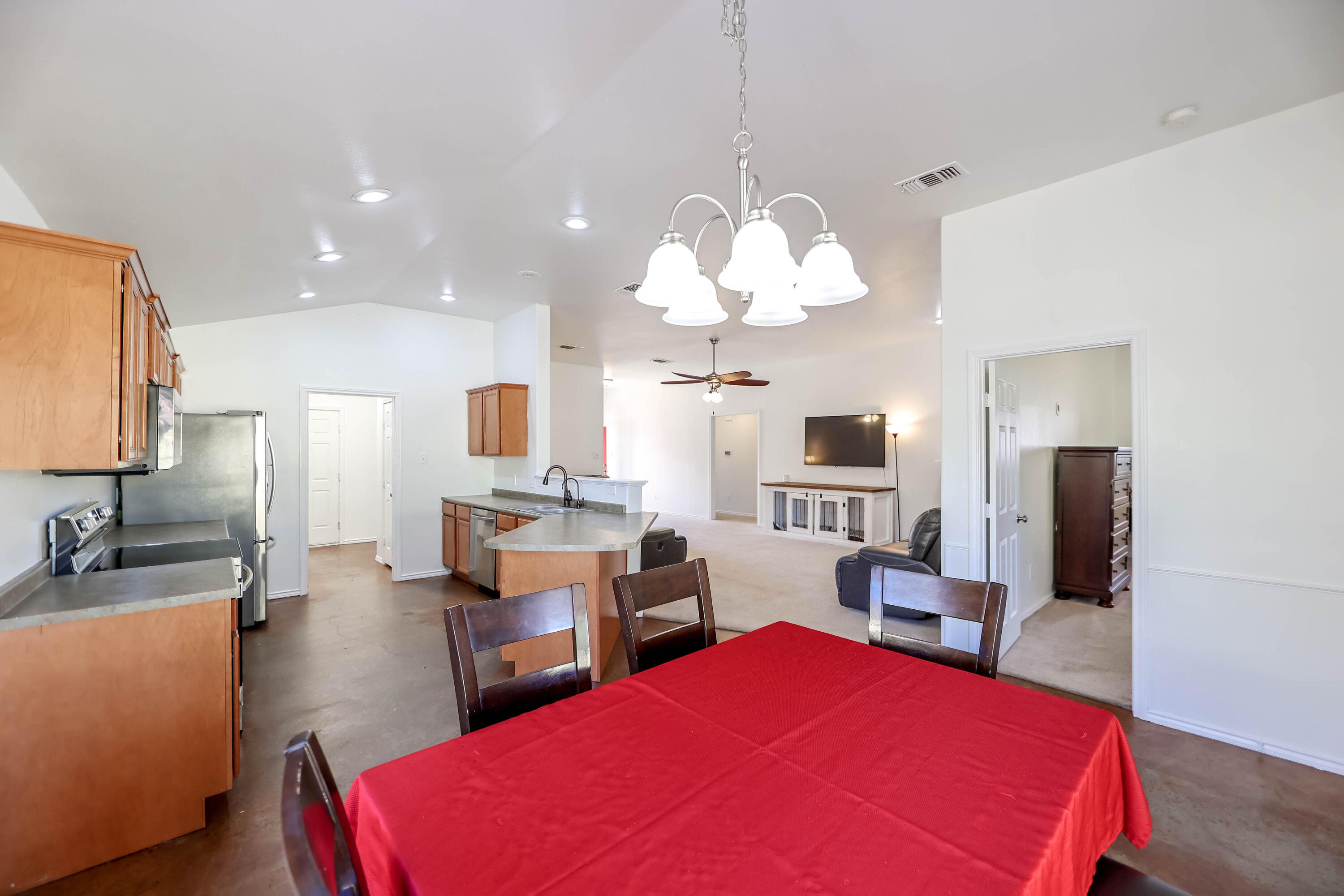 6718 92nd Street Lubbock, TX 79424 - Photo 8 of 31 a living room with furniture a fireplace and a chandelier