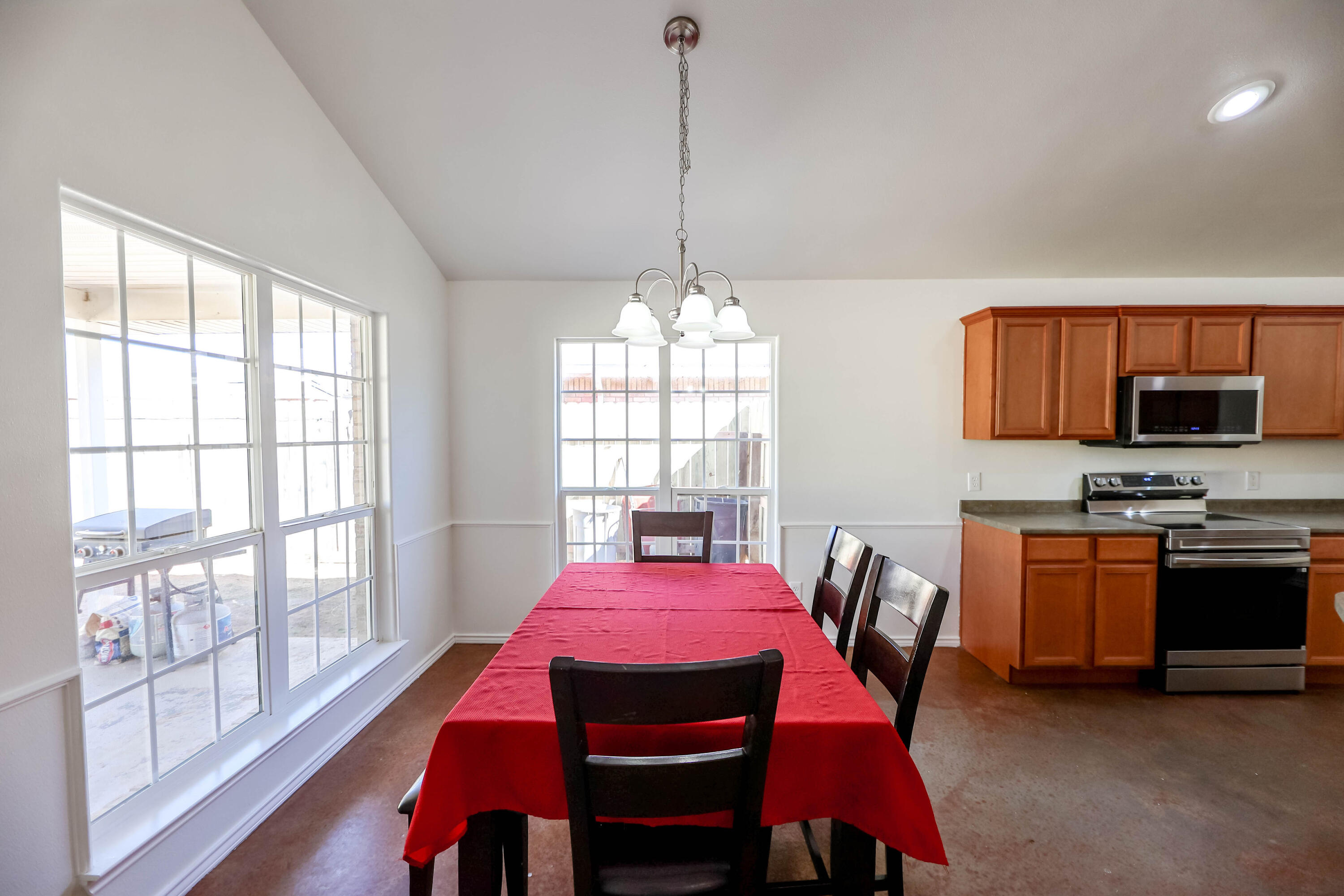 6718 92nd Street Lubbock, TX 79424 - Photo 9 of 31 a view of a dining room with furniture a chandelier and wooden floor