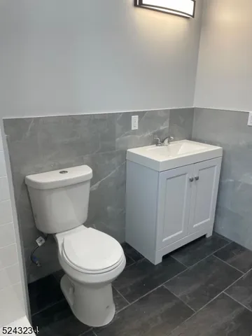 a white toilet sitting next to a bathroom sink