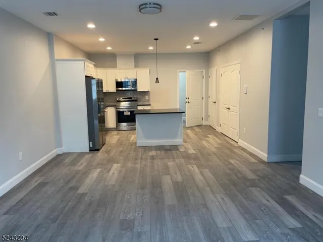 a view of kitchen with stainless steel appliances refrigerator microwave and stove