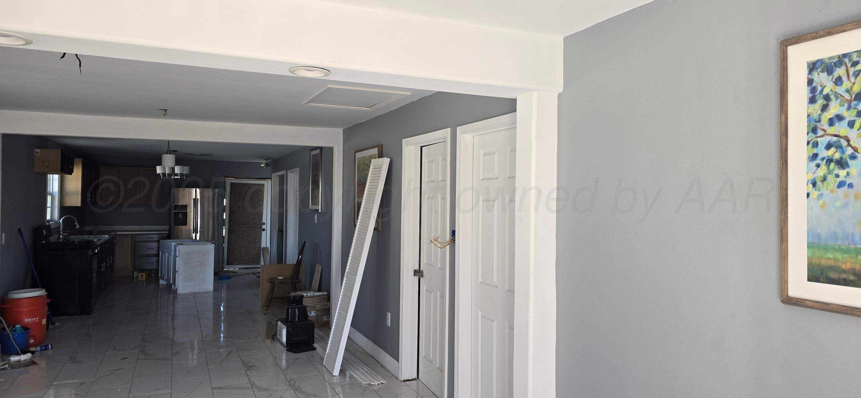 904 Elmore Street Borger, TX 79007 - Photo 5 of 20 a view of a hallway with closet and a window