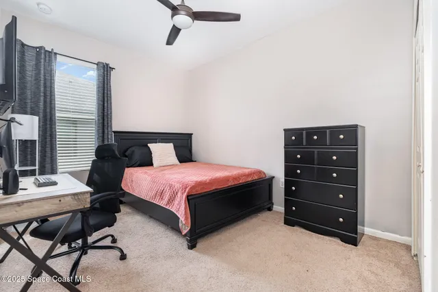 a bedroom with a bed and a desk