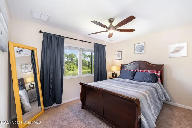a bedroom with a large bed and a window
