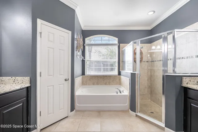 a spacious bathroom with a tub shower and window