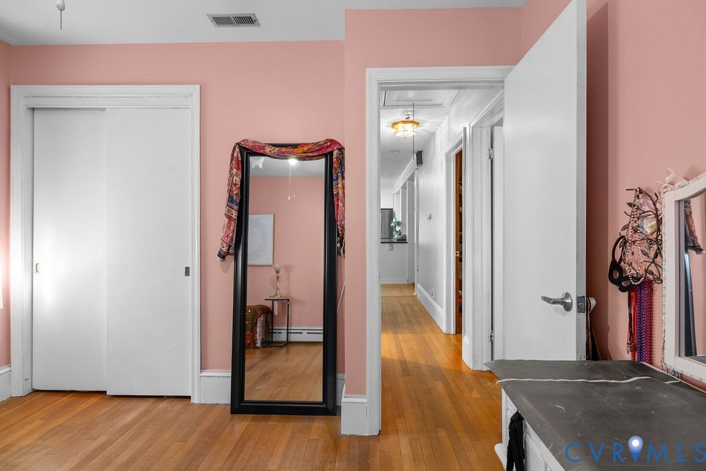 9500 West Providence Road Chesterfield, VA 23236 - Photo 19 of 39 a view of a hallway with wooden floor and a livingroom with furniture