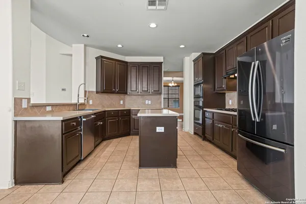 a kitchen with stainless steel appliances granite countertop refrigerator a sink and dishwasher