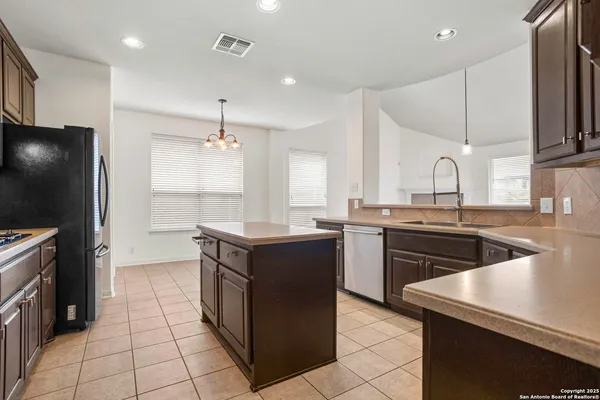 a kitchen with a sink stove and refrigerator