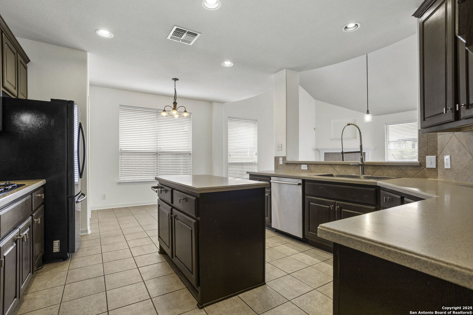 3415 Highline Trail San Antonio, TX 78261 - Photo 4 of 24 a kitchen with a sink stove and refrigerator