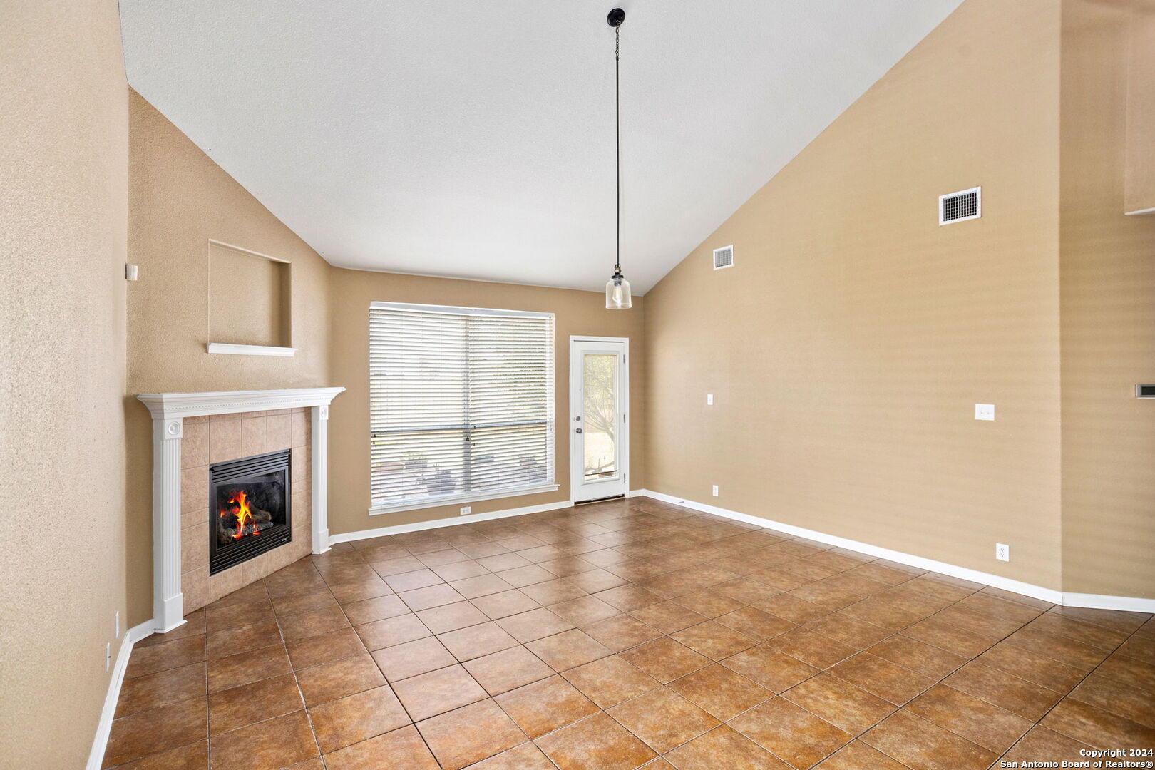 3415 Highline Trail San Antonio, TX 78261 - Photo 7 of 24 a view of an empty room with a fireplace and a window